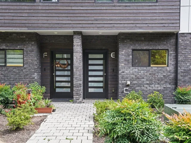 a front view of a building with potted plants