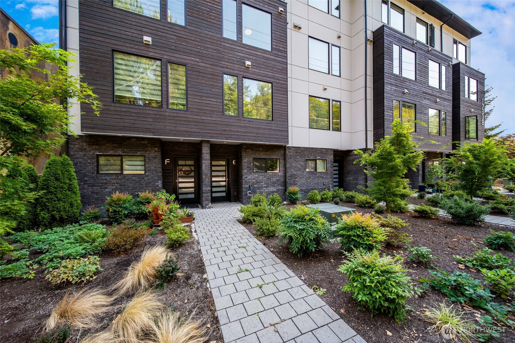17338 Bothell Way Northeast, Unit E Bothell, WA 98011 - Photo 3 of 26 a front view of a building with garden