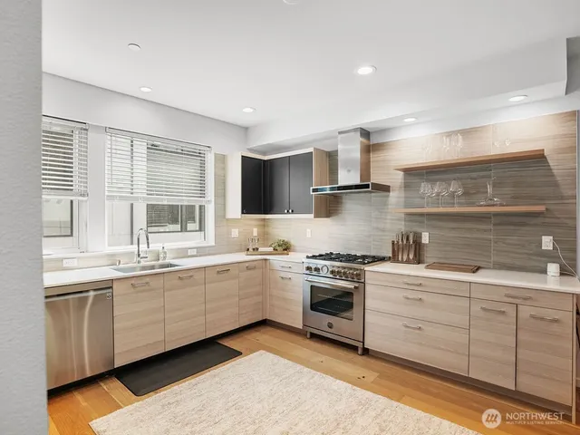 a kitchen with a sink stove and cabinets