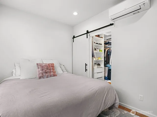 a bedroom with a bed and a walk in closet