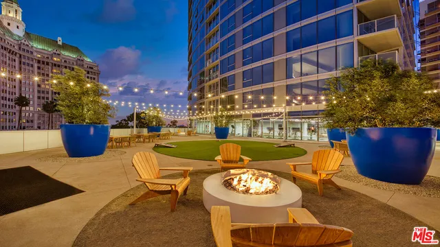a view of a swimming pool with outdoor seating