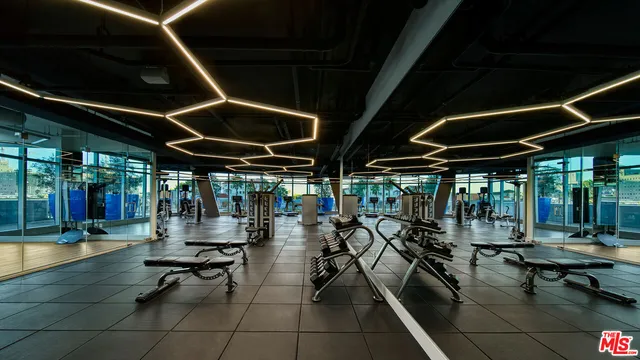 a room with gym equipment and a table