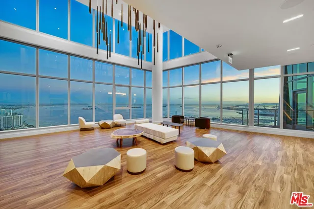 a view of a dining room with furniture a chandelier and wooden floor