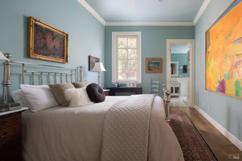 a bedroom with bed couch and window