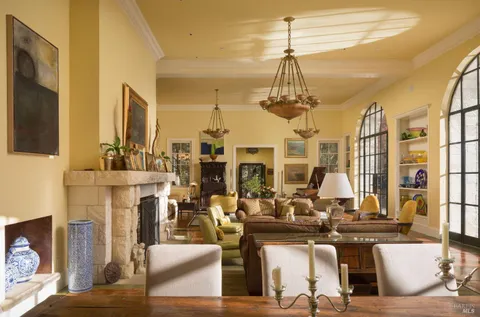 a living room with fireplace furniture and a chandelier