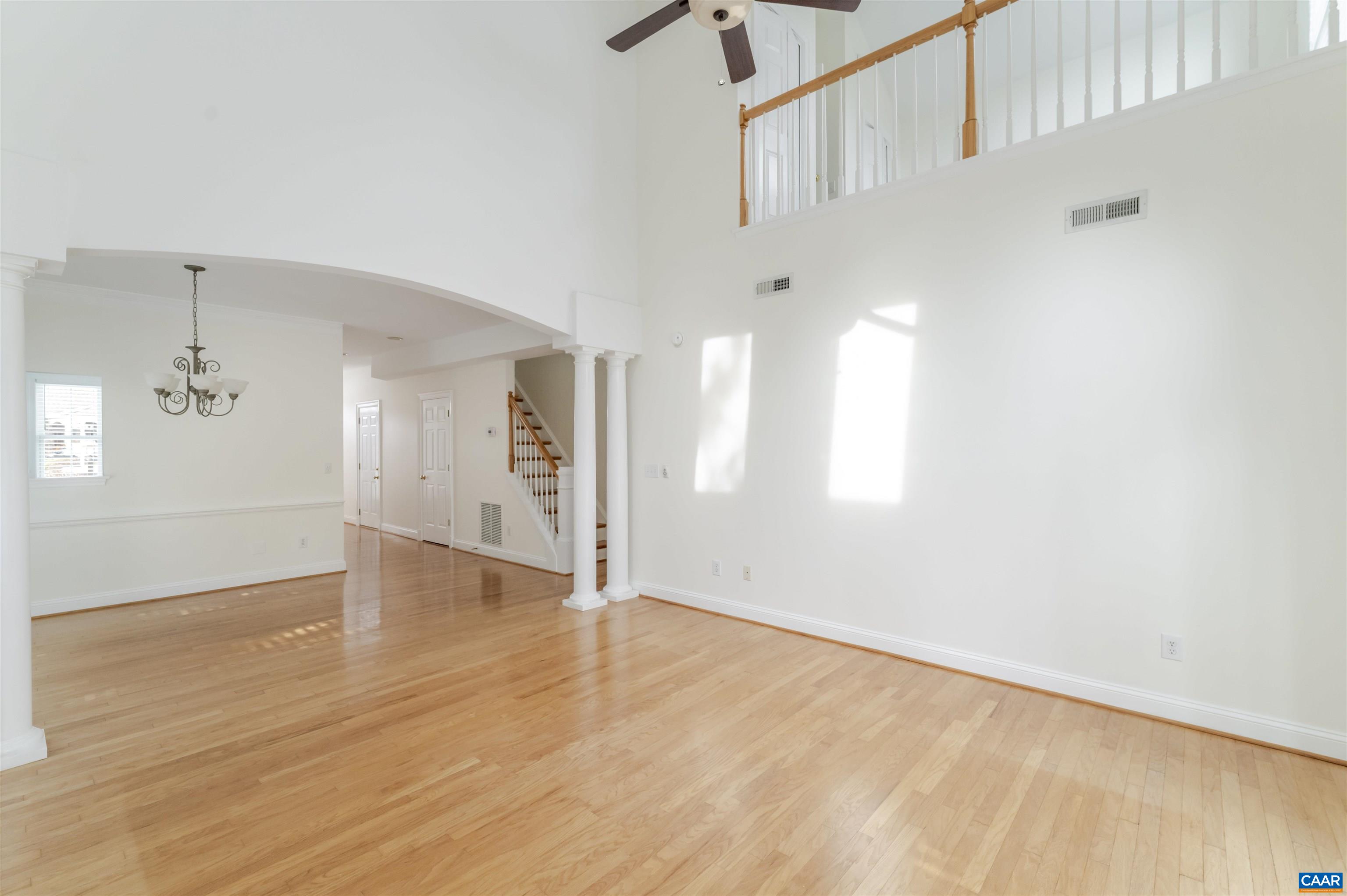 1202 Stonegate Way Crozet, VA 22932 - Photo 11 of 42 a view of an empty room with wooden floor and a window