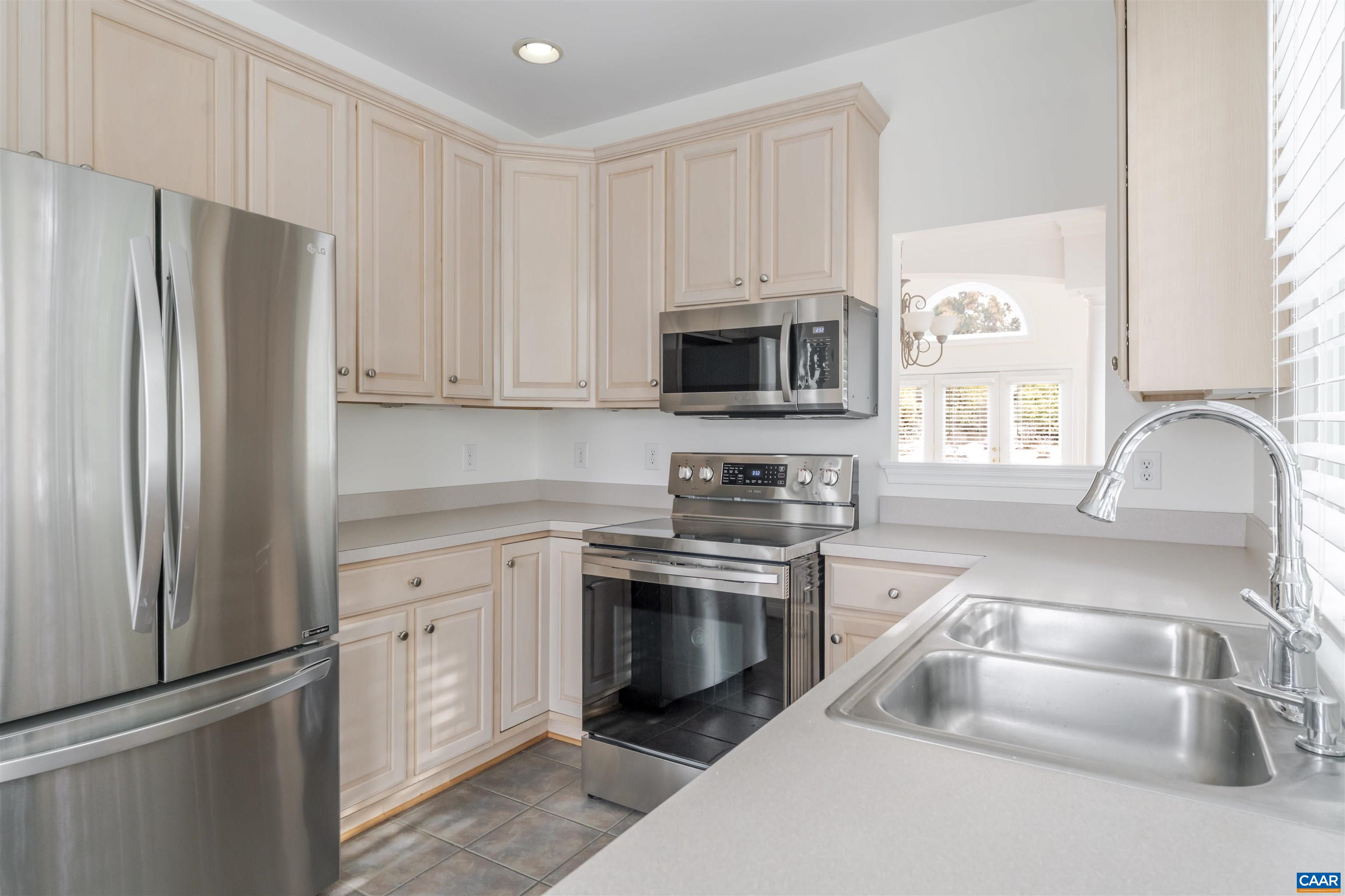 1202 Stonegate Way Crozet, VA 22932 - Photo 12 of 42 a kitchen with granite countertop a sink stove and refrigerator