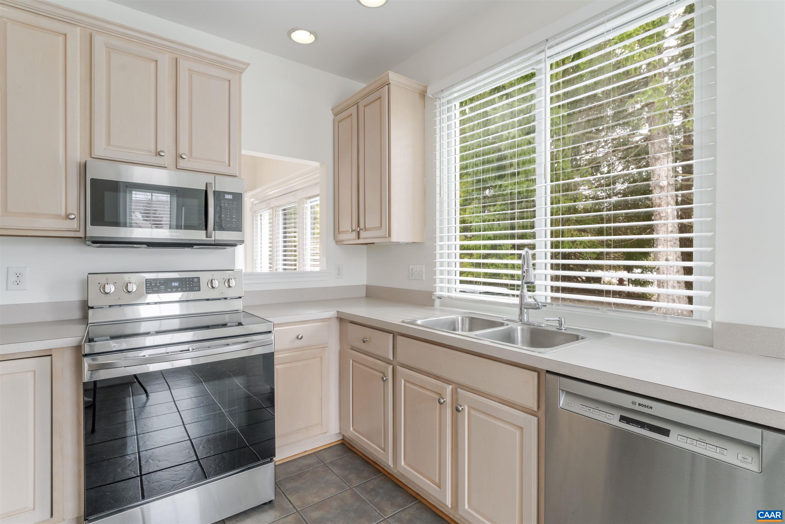 1202 Stonegate Way Crozet, VA 22932 - Photo 14 of 42 a kitchen with cabinets appliances a sink and a window