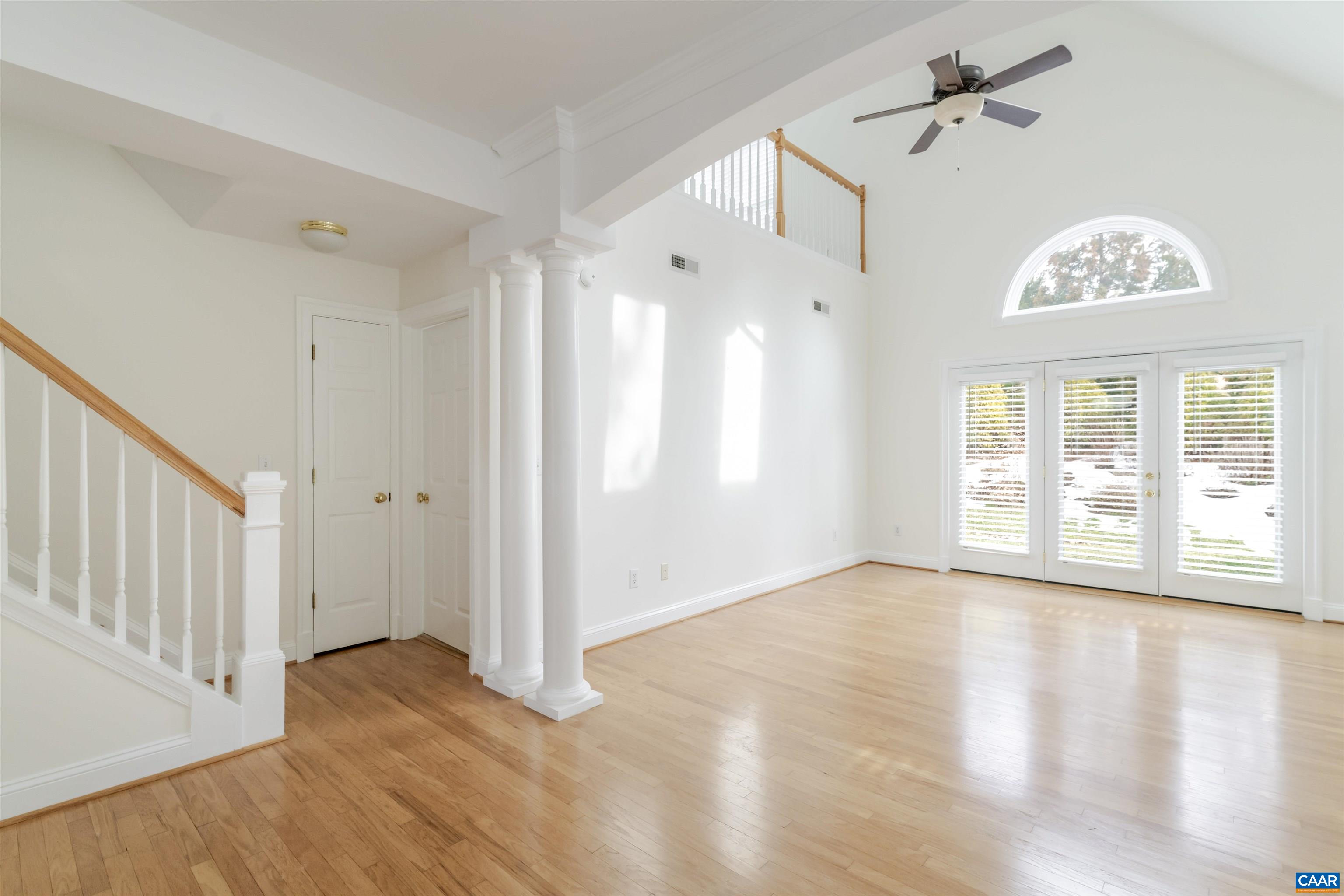 1202 Stonegate Way Crozet, VA 22932 - Photo 7 of 42 a view of an empty room with a window and wooden floor