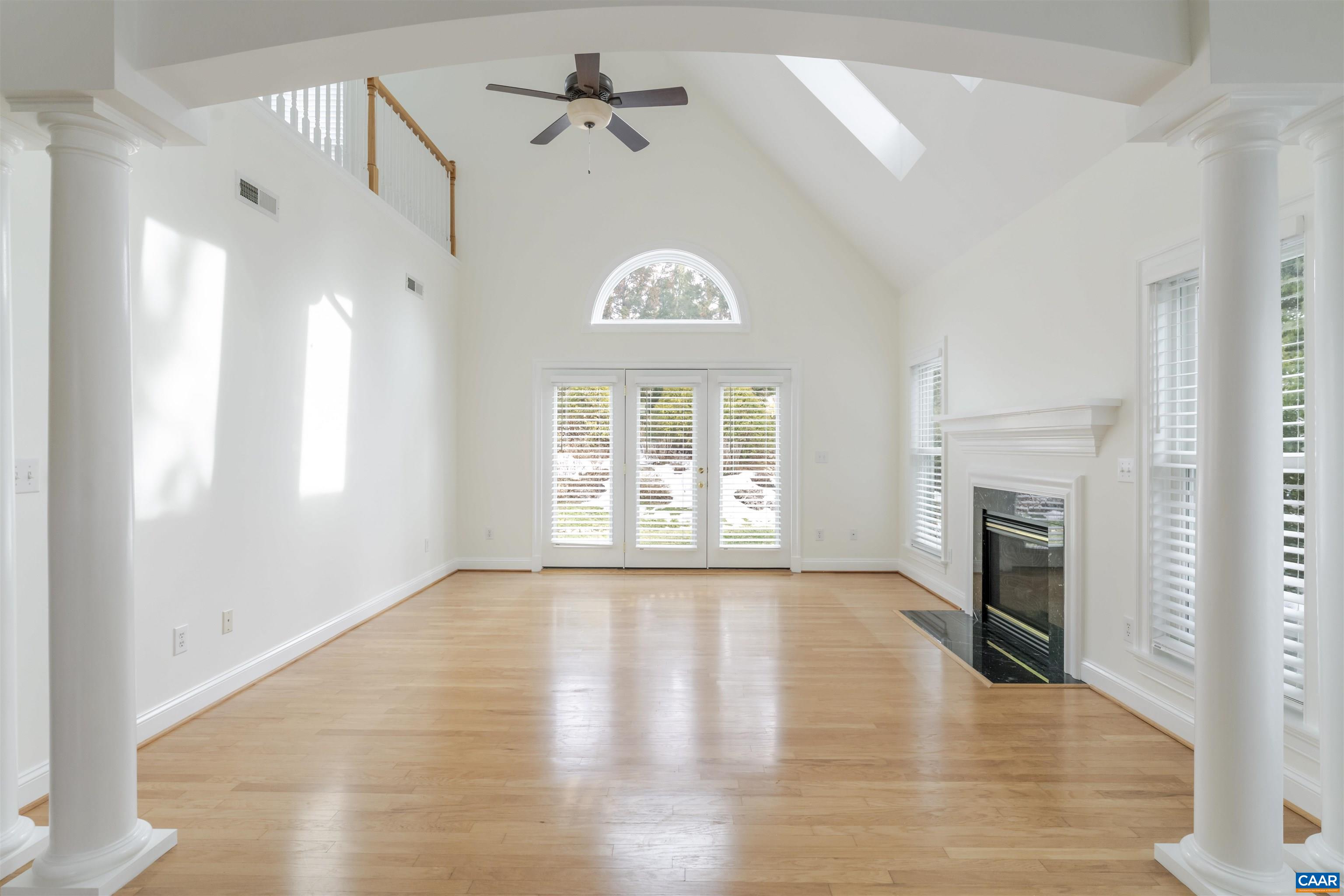 1202 Stonegate Way Crozet, VA 22932 - Photo 8 of 42 a view of an empty room with a window and a kitchen