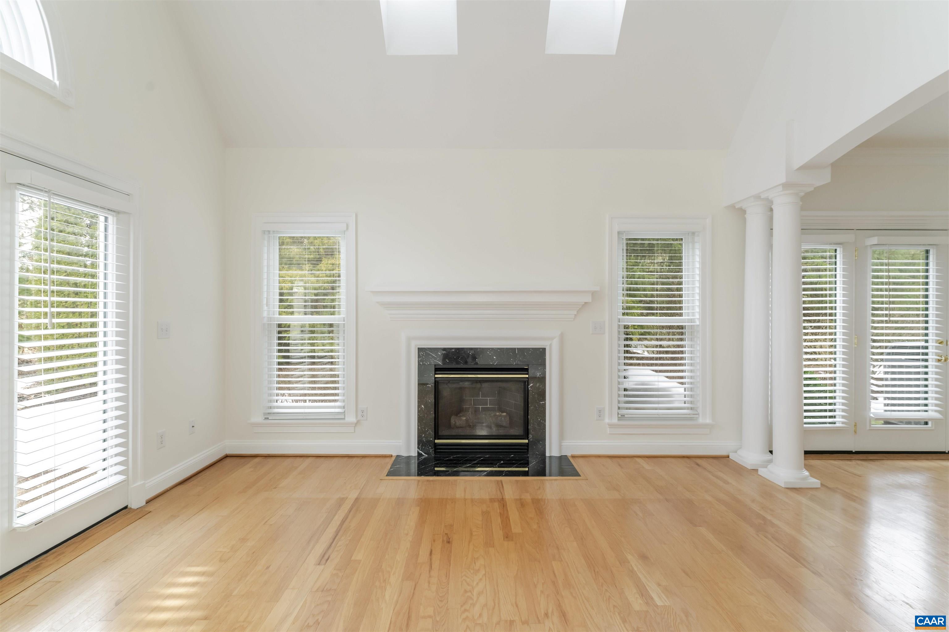 1202 Stonegate Way Crozet, VA 22932 - Photo 9 of 42 an empty room with floor to ceiling window and fireplace