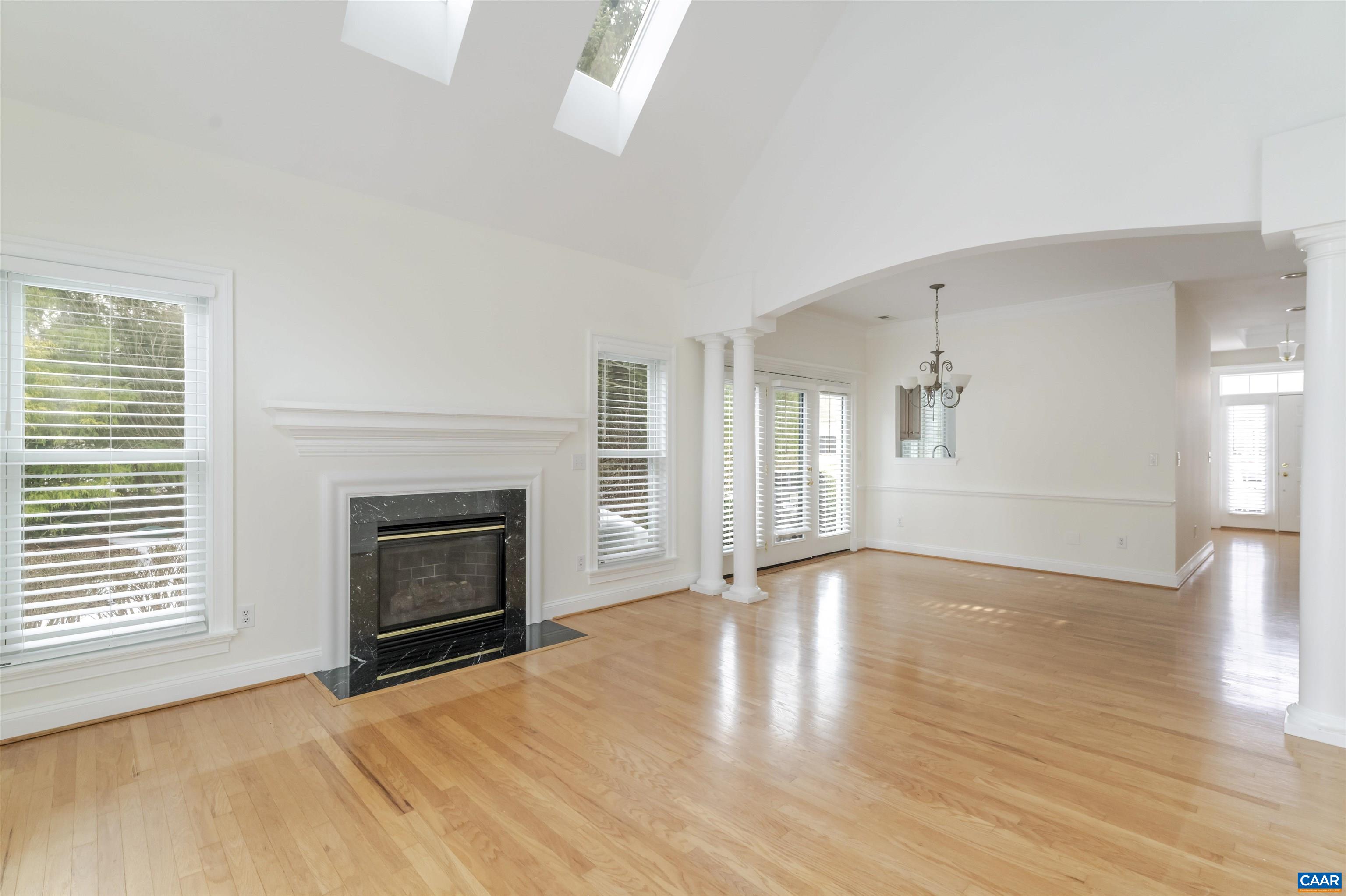 1202 Stonegate Way Crozet, VA 22932 - Photo 10 of 42 a view of empty room with wooden floor and fireplace