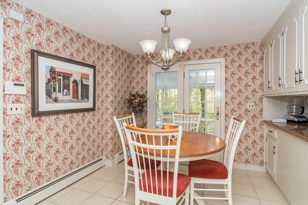 17 Colonial Drive Framingham, MA 01701 - Photo 9 of 27 a dining room with wooden floor and chandelier