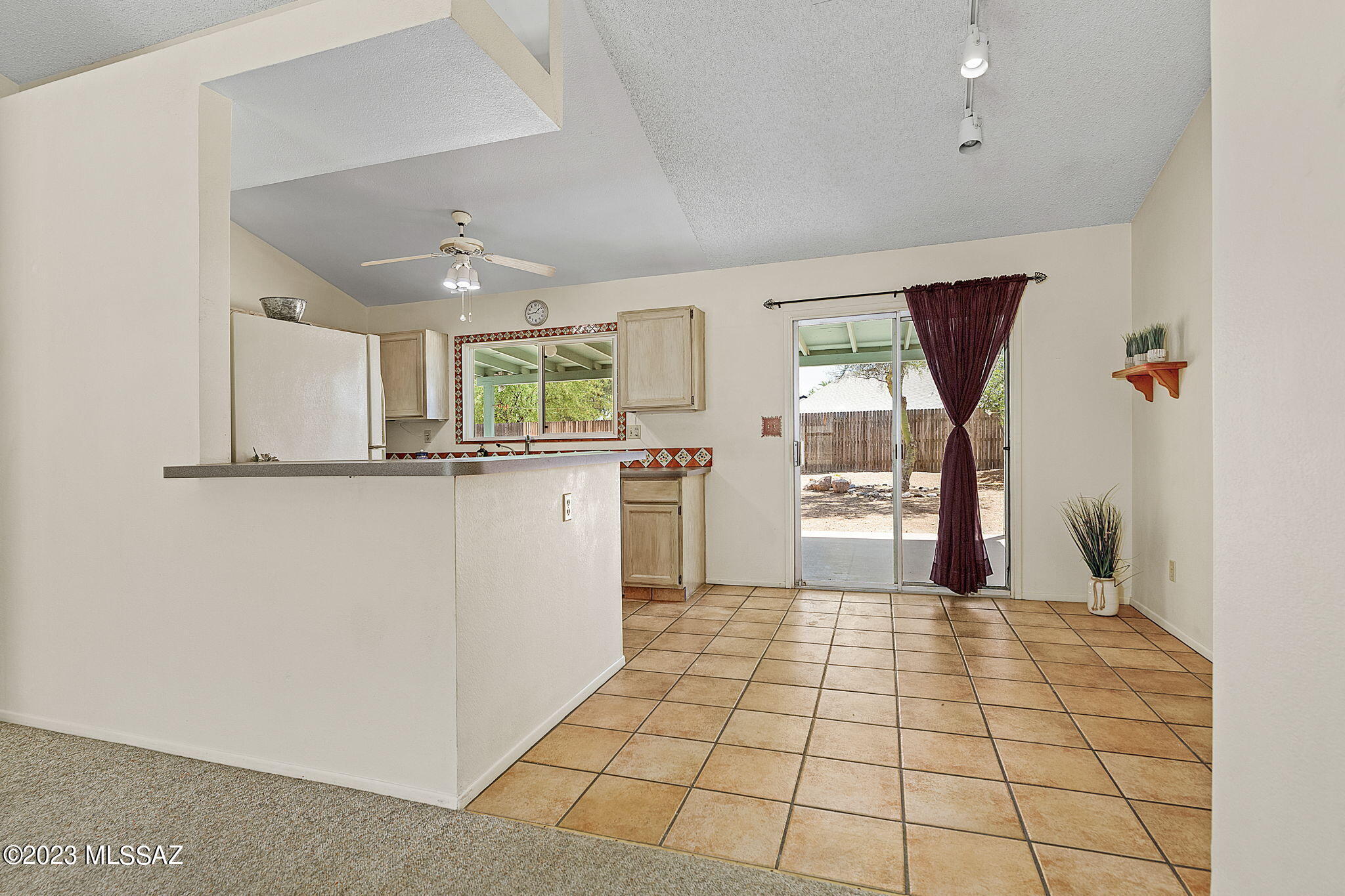 10610 Keystone Road East Tucson, AZ 85730 - Photo 10 of 35 a kitchen with granite countertop a stove a sink and a refrigerator