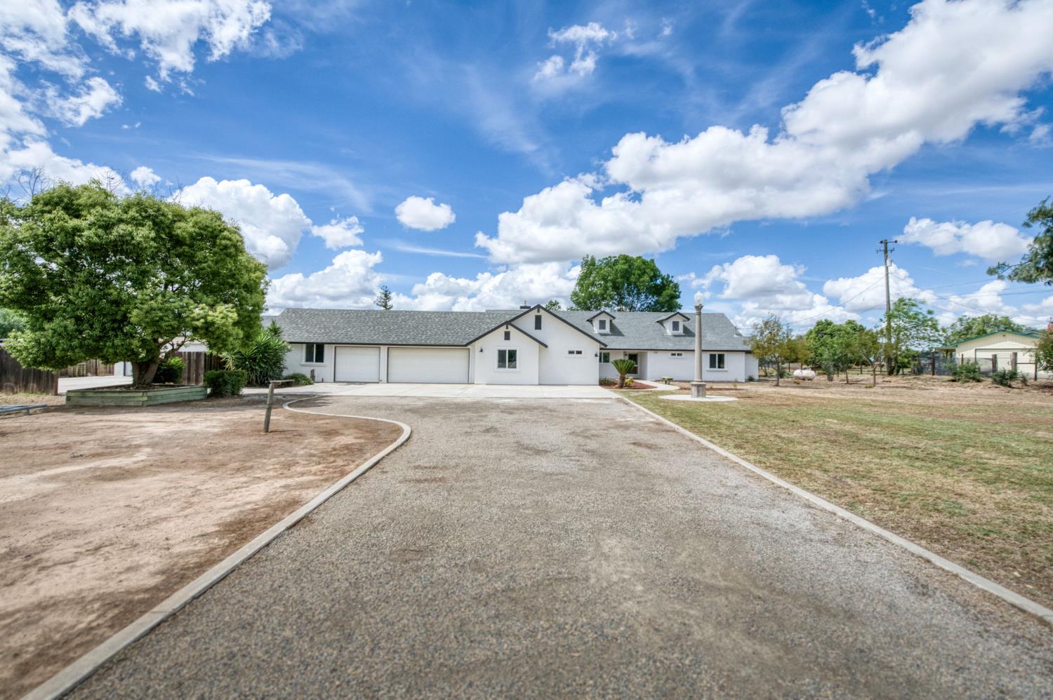 16564 Monreal Road Madera, CA 93636 - Photo 59 of 59 a view of a street with a building in the background