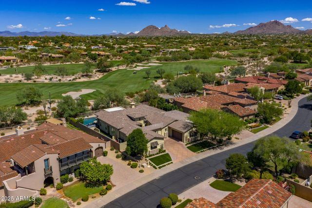an aerial view of residential houses with outdoor space and river