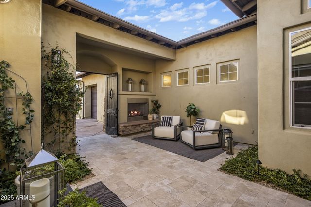 an empty room with a chandelier fan and windows