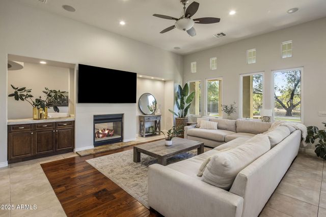 a living room with furniture and a view of kitchen