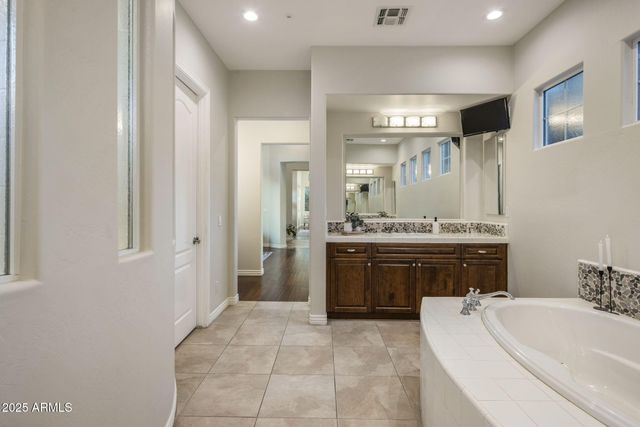 a spacious bathroom with a sink and a mirror