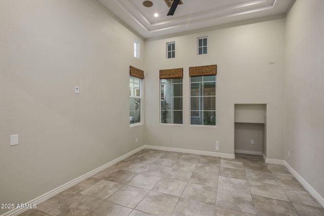 a view of a workspace with wooden floor and a window