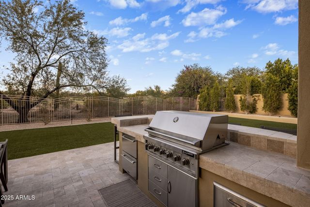 a front view of a house with a yard table and chairs