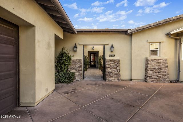 a lobby with furniture and potted plants