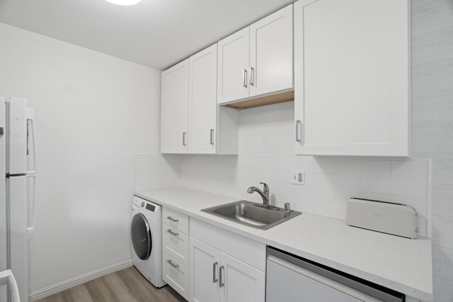 2025 California Street, Unit 40 Mountain View, CA 94040 - Photo 13 of 31 a kitchen with white cabinets and sink