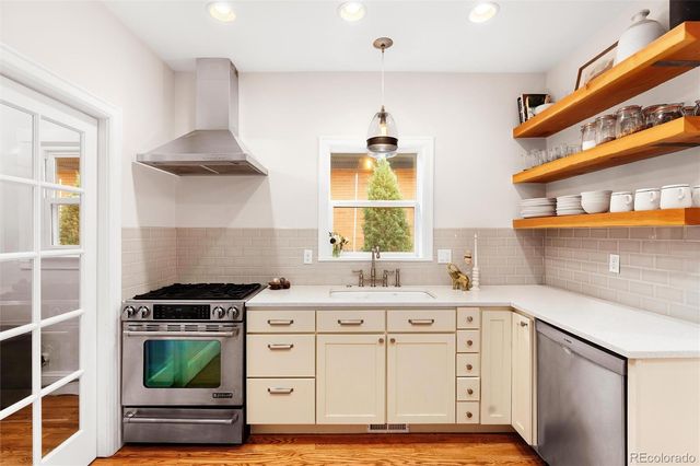 a white refrigerator freezer and a stove sitting inside of a kitchen