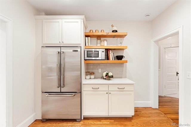 a kitchen with stainless steel appliances a sink stove and refrigerator