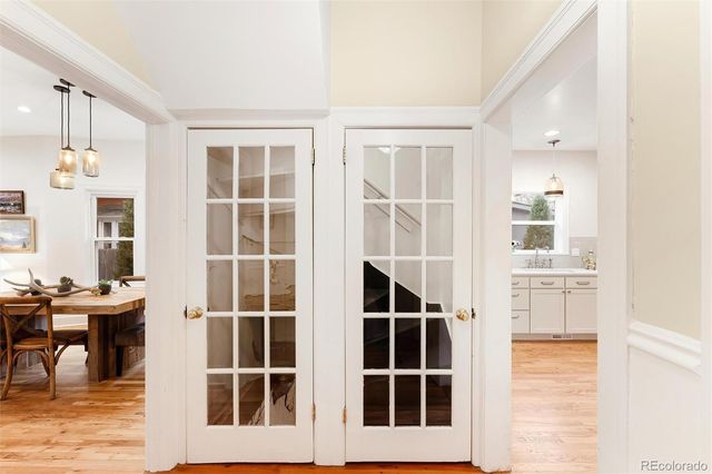 a view of a hallway with wooden floor and entryway