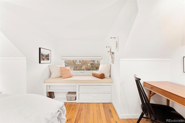 a bedroom with a bed and a table in it