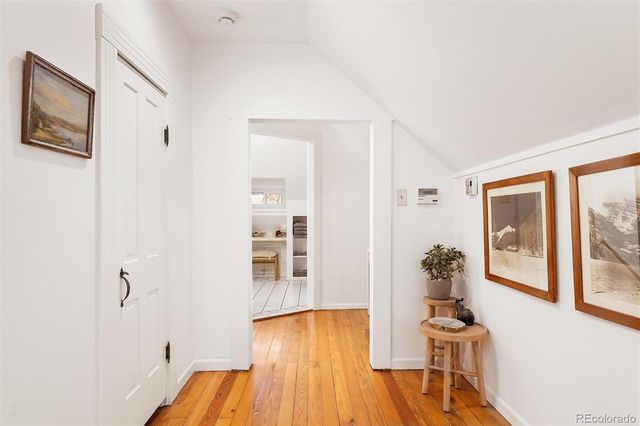 a view of a bedroom with wooden floor