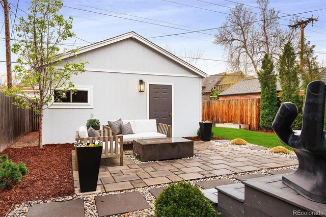 a front view of a house with a garden and patio