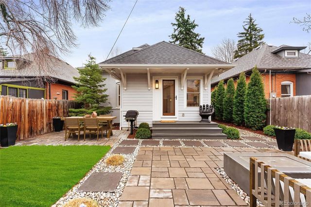 a view of a patio with couches table and chairs and potted plants