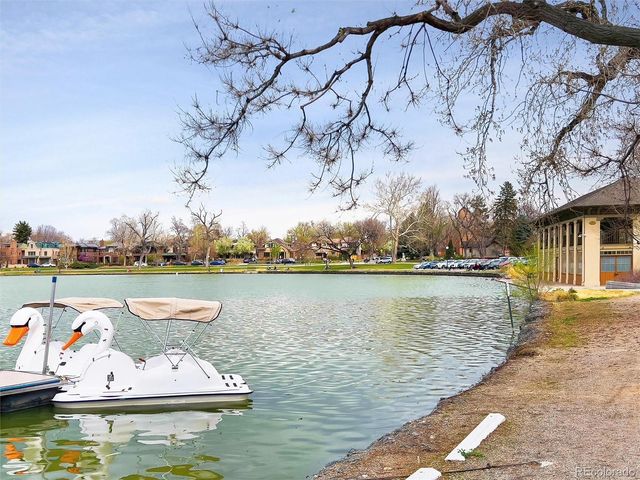 an aerial view of a house with a garden and lake view