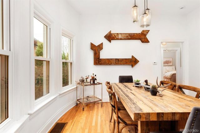 a living room with stainless steel appliances furniture stove and a window