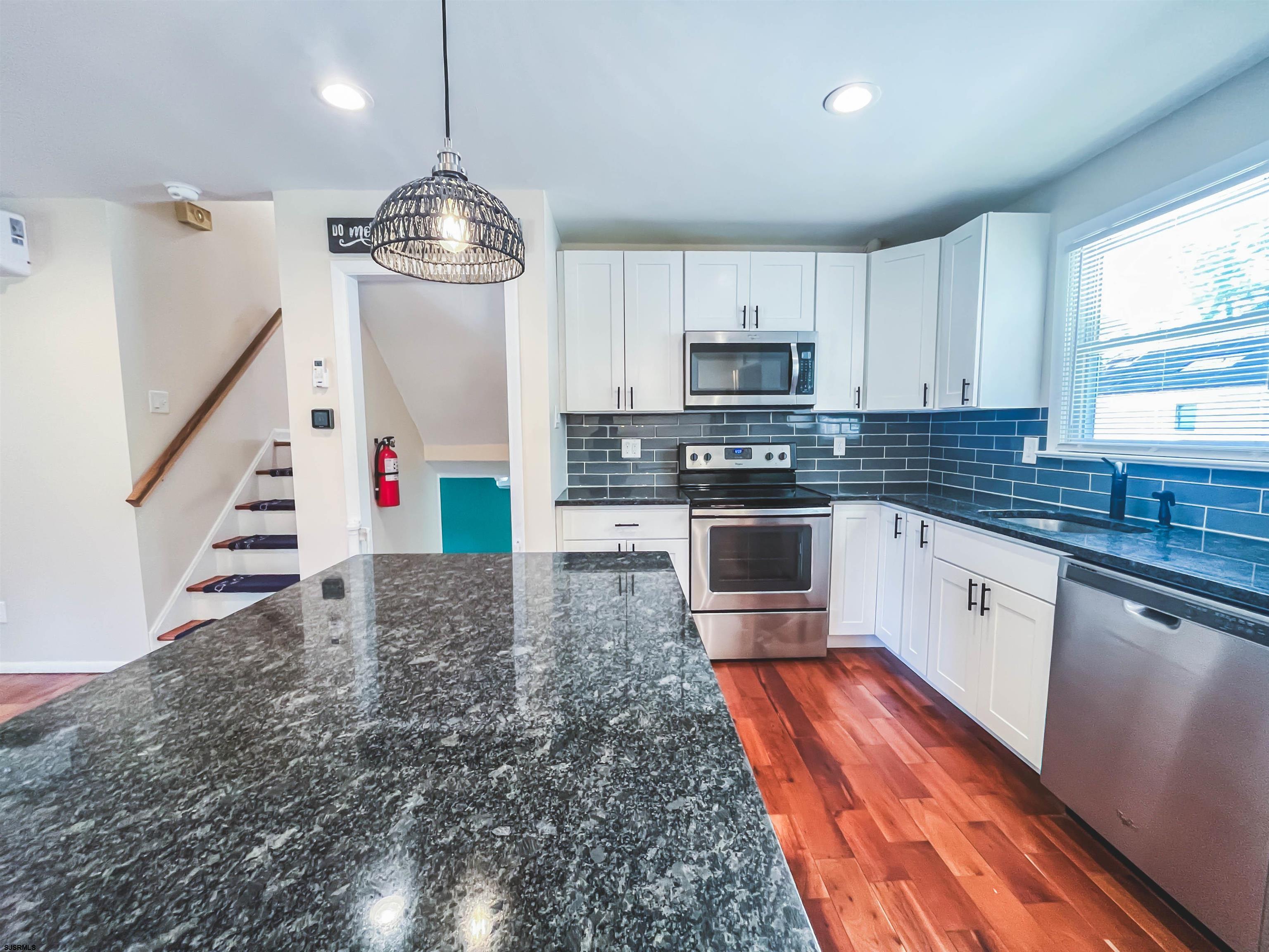 518 Delaware Avenue Absecon, NJ 08201 - Photo 10 of 38 a kitchen with stainless steel appliances granite countertop a stove sink and cabinets