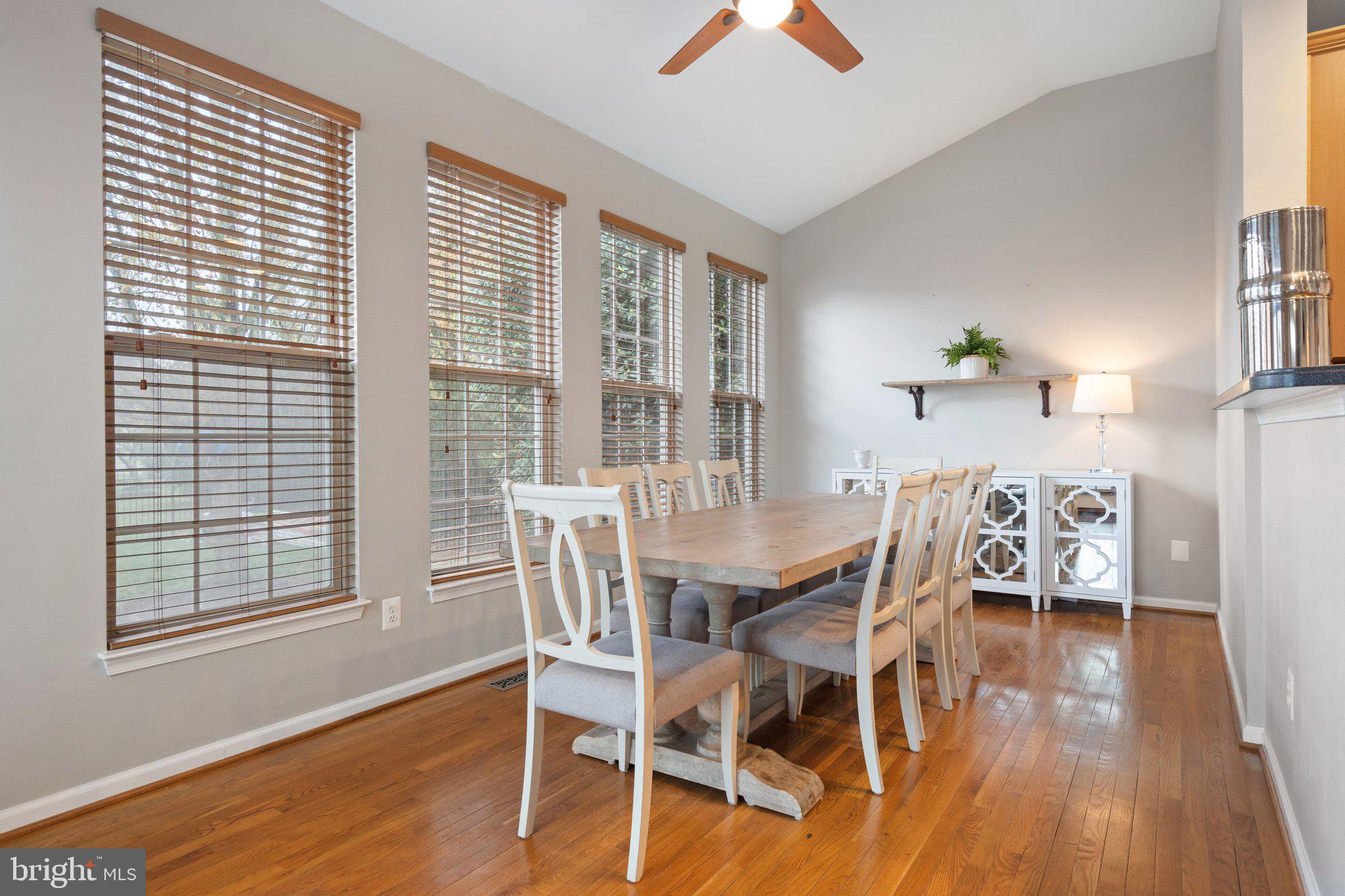 6754 Stapleton Place Gainesville, VA 20155 - Photo 14 of 39 a view of a dining room with furniture and wooden floor