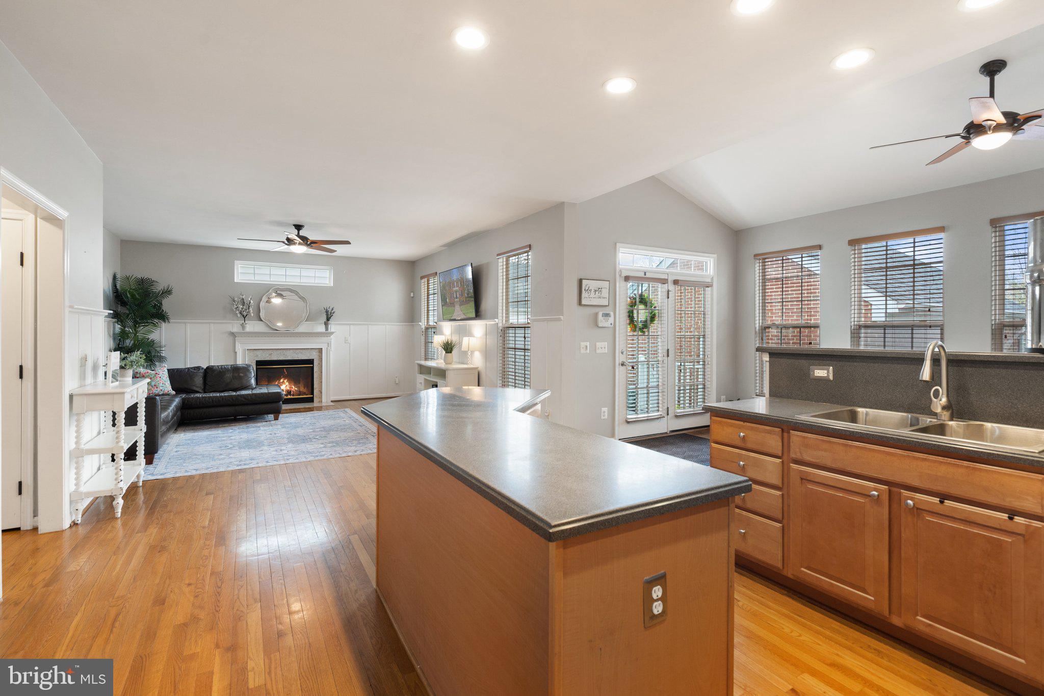 6754 Stapleton Place Gainesville, VA 20155 - Photo 15 of 39 a kitchen with stainless steel appliances granite countertop a sink stove and wooden floor