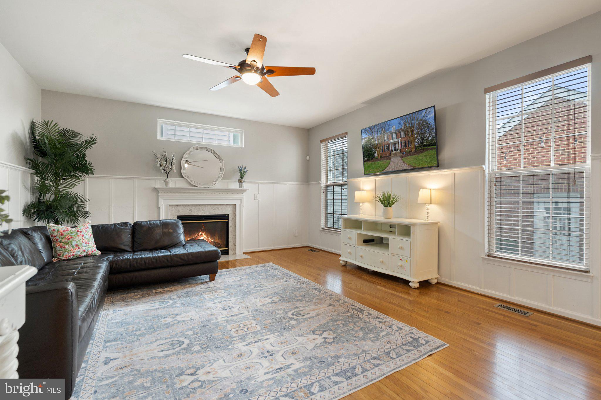 6754 Stapleton Place Gainesville, VA 20155 - Photo 17 of 39 a living room with furniture and a fireplace