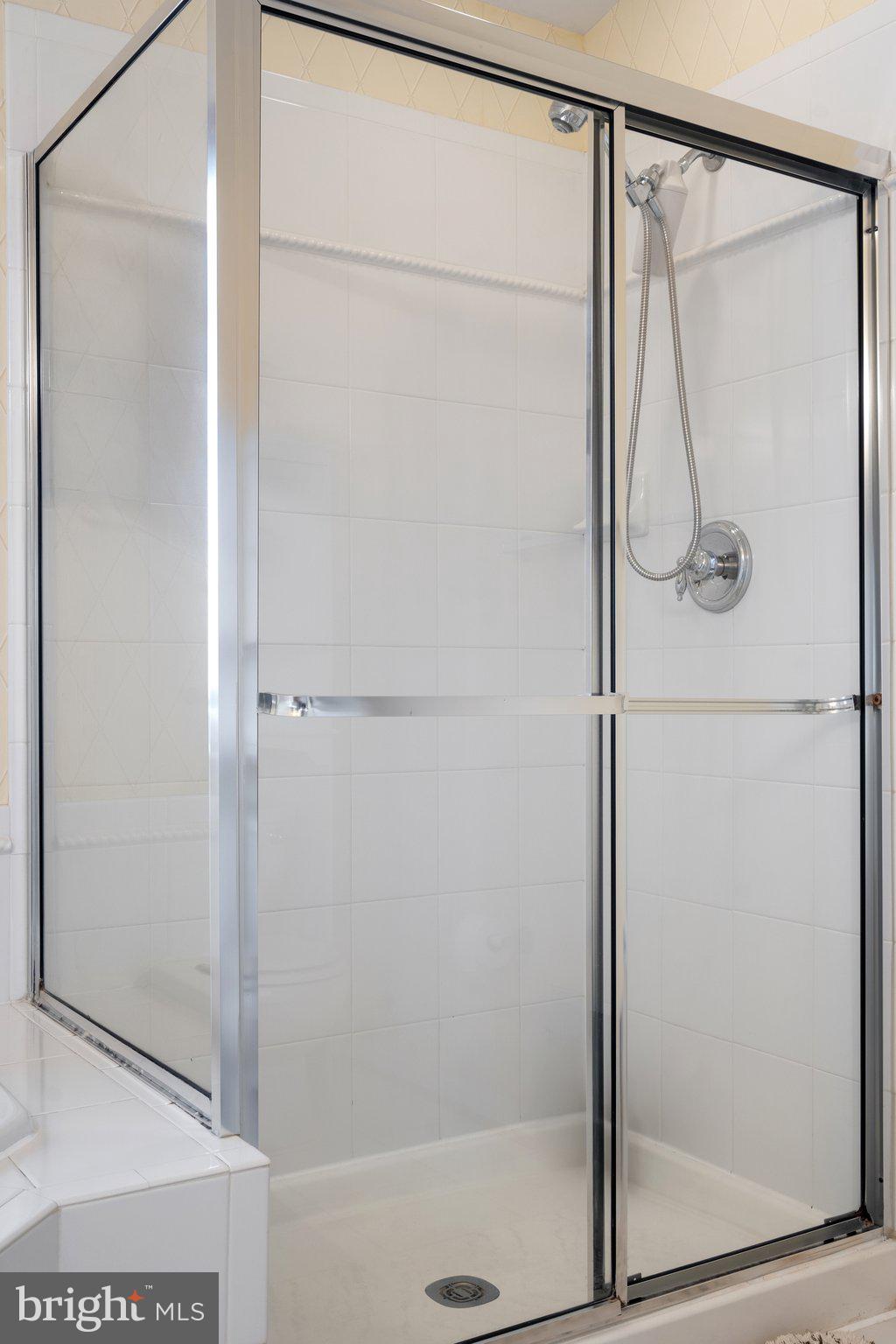 6754 Stapleton Place Gainesville, VA 20155 - Photo 23 of 39 a bathroom with a glass shower door