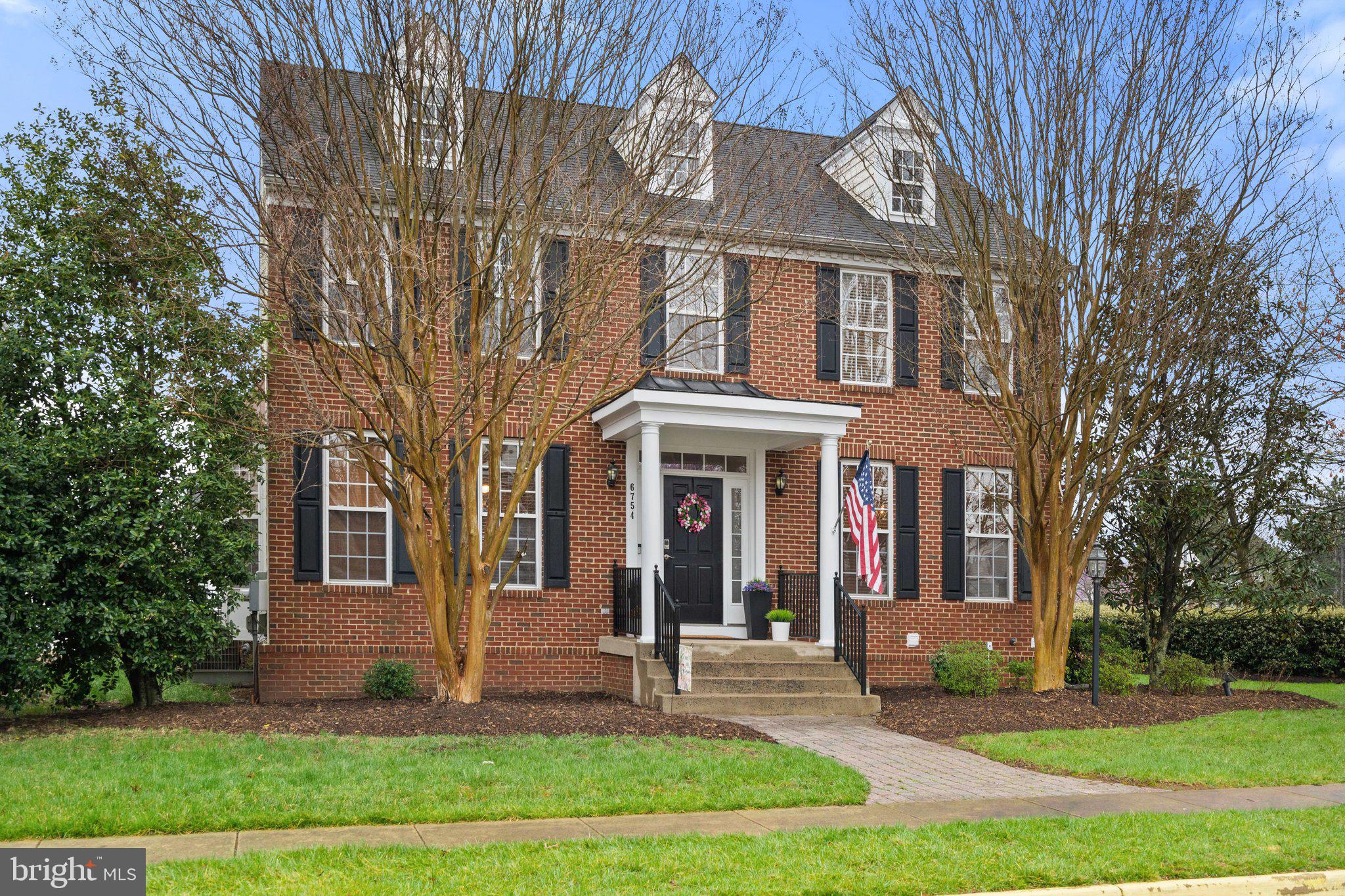 6754 Stapleton Place Gainesville, VA 20155 - Photo 3 of 39 a front view of a house with yard and green space