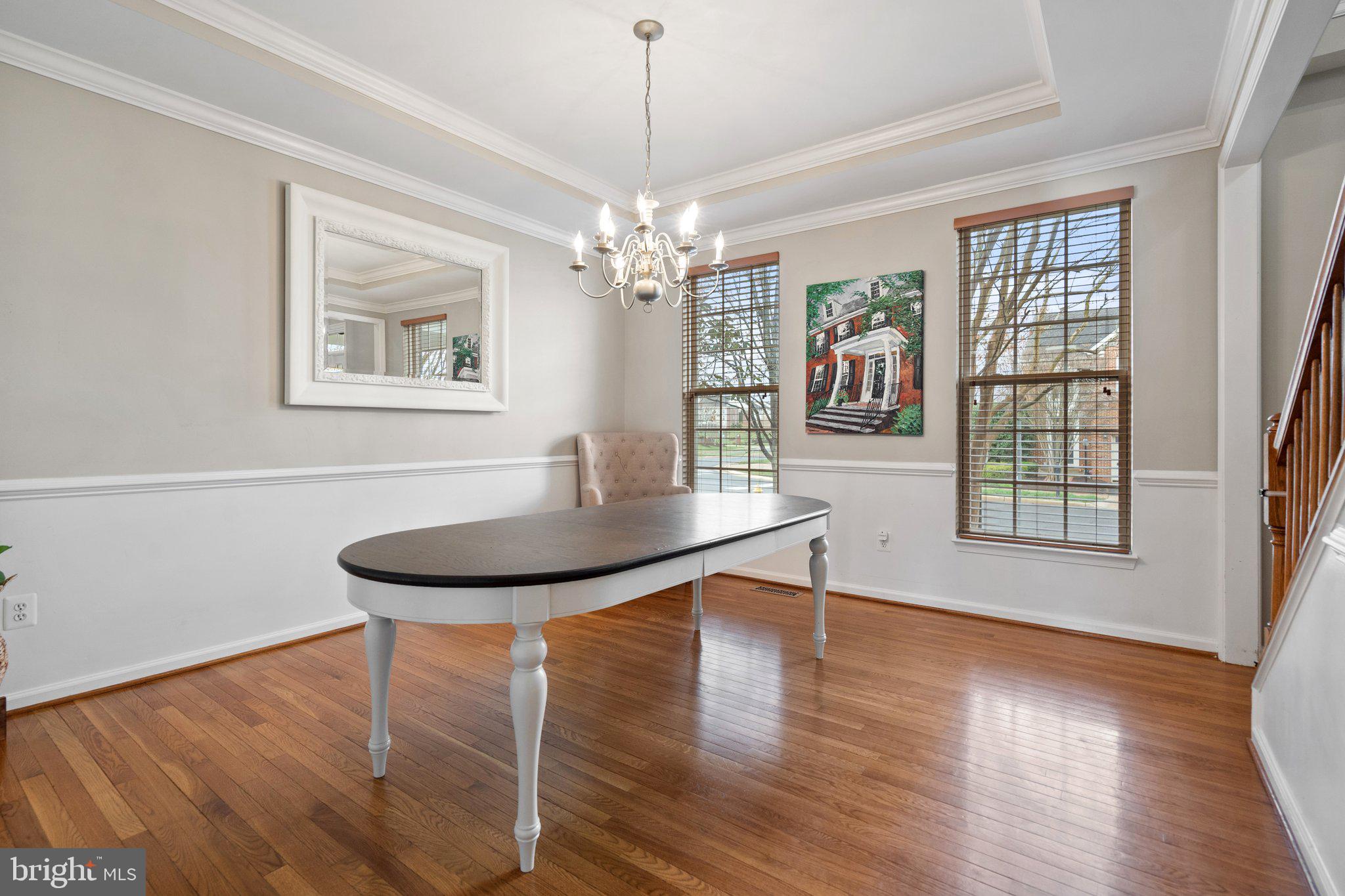6754 Stapleton Place Gainesville, VA 20155 - Photo 9 of 39 a view of a dining room with furniture wooden floor and chandelier