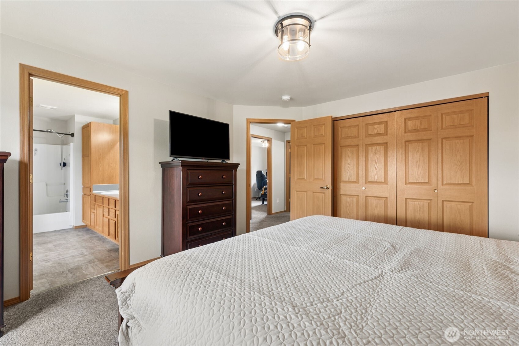 17837 Gilbert Street Southeast Tenino, WA 98589 - Photo 14 of 32 a large bedroom with a bed and a flat screen tv