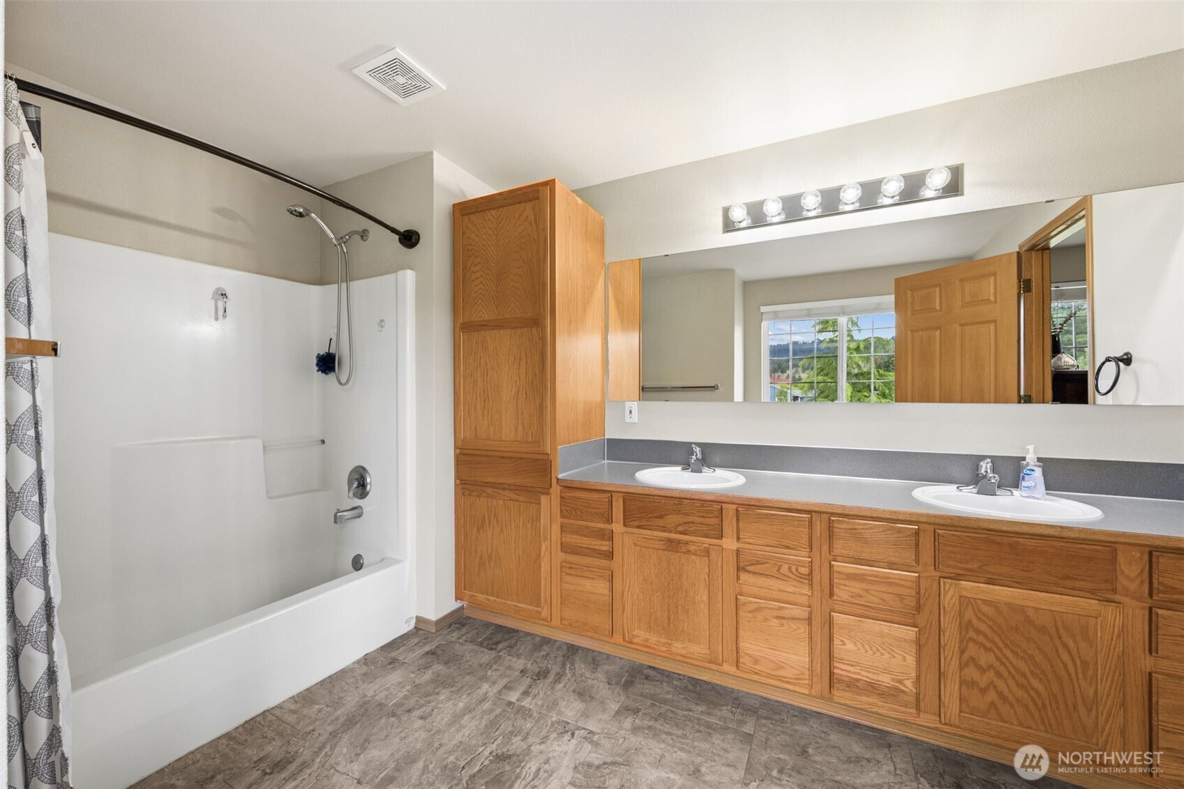 17837 Gilbert Street Southeast Tenino, WA 98589 - Photo 15 of 32 a spacious bathroom with a granite countertop sink a mirror a shower and a bathtub