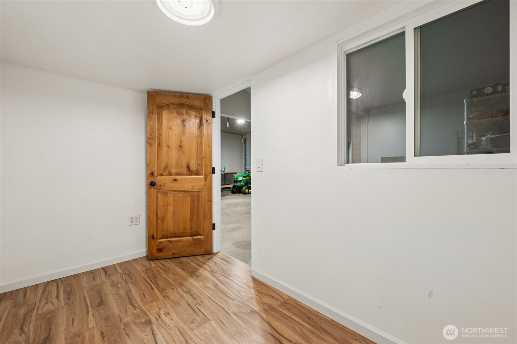 17837 Gilbert Street Southeast Tenino, WA 98589 - Photo 28 of 32 an empty room with wooden floor and mirror