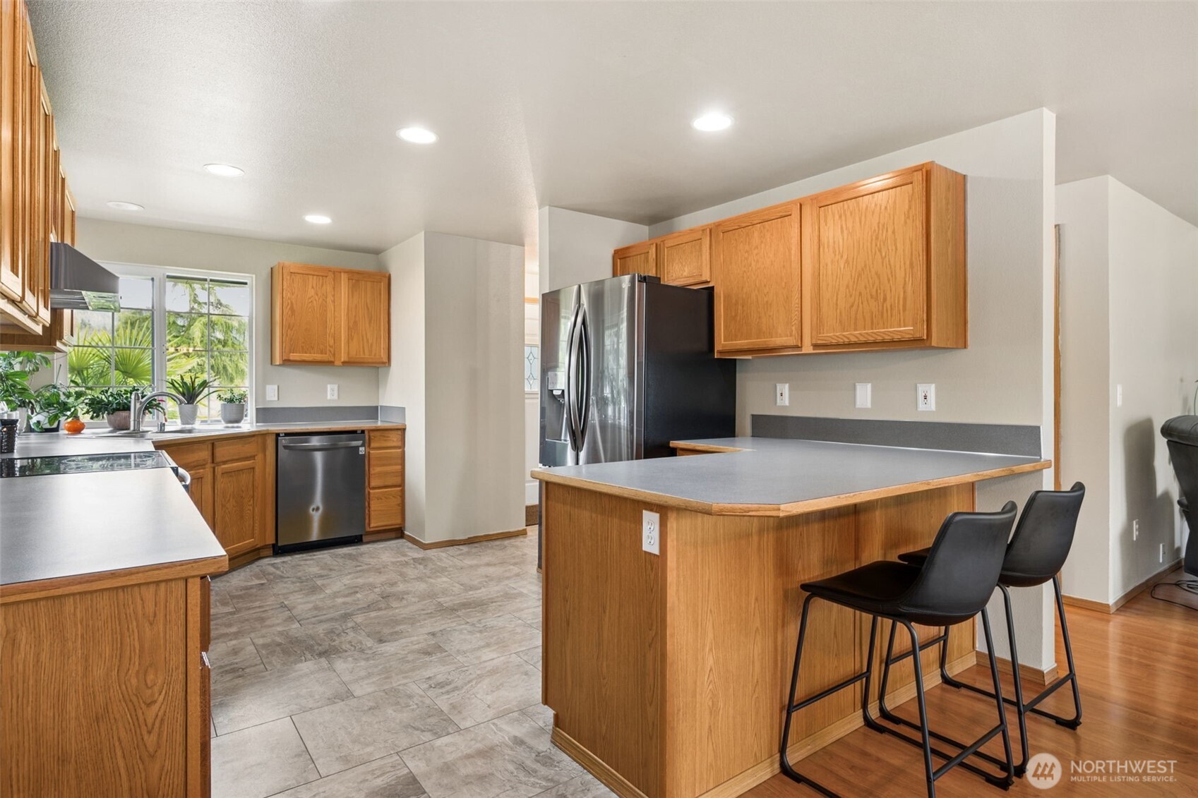 17837 Gilbert Street Southeast Tenino, WA 98589 - Photo 3 of 32 a kitchen with stainless steel appliances granite countertop a stove a refrigerator a sink a dining table and chairs