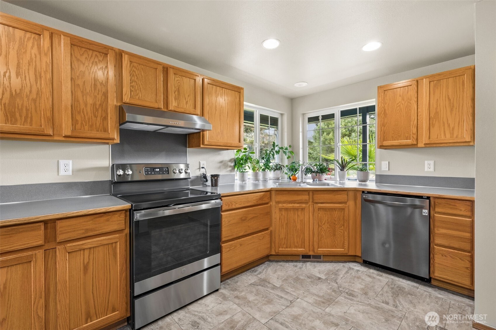 17837 Gilbert Street Southeast Tenino, WA 98589 - Photo 4 of 32 a kitchen with stainless steel appliances granite countertop wooden cabinets and a stove top oven