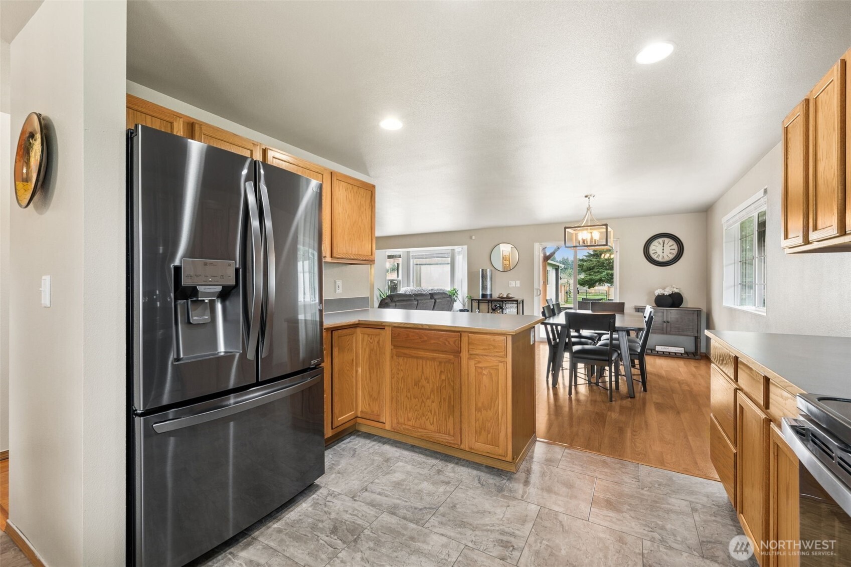 17837 Gilbert Street Southeast Tenino, WA 98589 - Photo 5 of 32 a kitchen with stainless steel appliances granite countertop a refrigerator a table and chairs