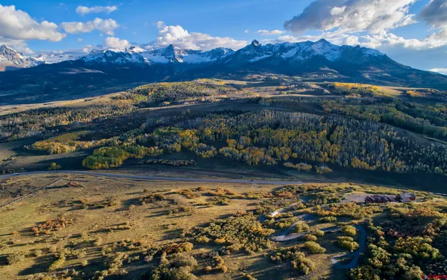 a view of a backyard of a house with a lake view